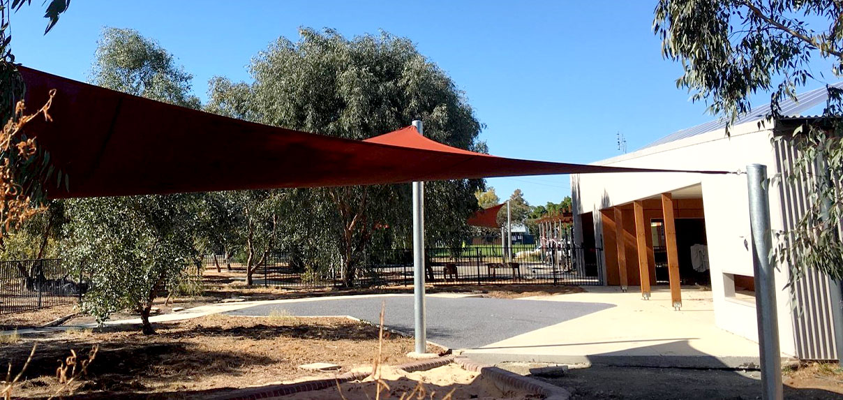 Outdoor shade structure providing a cool, sheltered area for community gatherings.