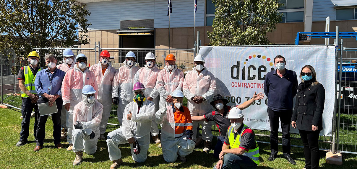 Team conducting safe and efficient building remediation work in protective gear.